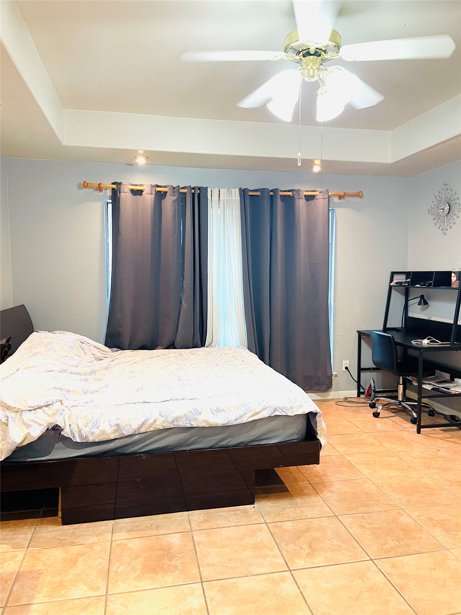 814 Broken Feather Trail Pflugerville, TX 78660 - Photo 9 of 24 Recessed lighting and a ceiling fan illuminate this spacious bedroom with tile flooring.