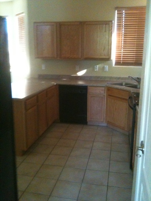 3235 West Maldonado Road Phoenix, AZ 85041 - Photo 4 of 17 a kitchen with a sink cabinets and window
