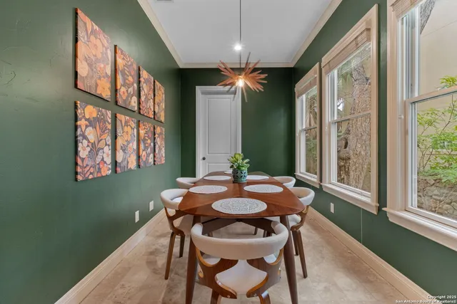 a dining room with furniture a chandelier and wooden floor