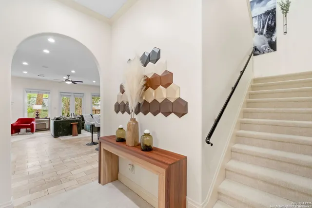 a view of hall way with furniture and stairs