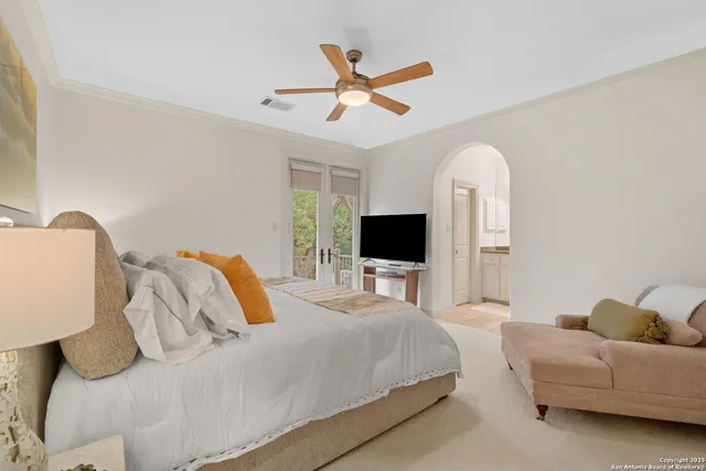 a en suite bathroom with a granite countertop sink a toilet and a mirror