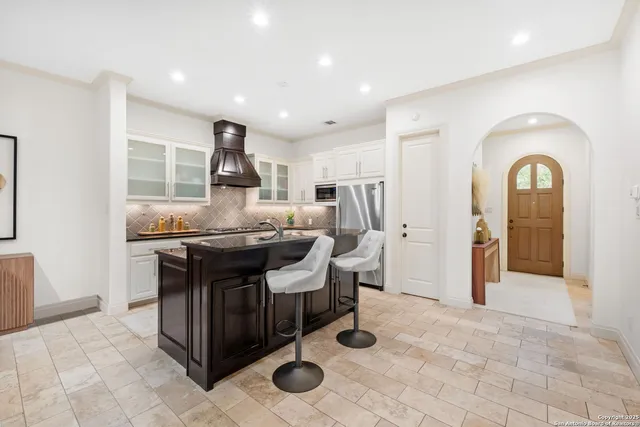 a living room with furniture a flat screen tv and outdoor view