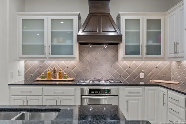 a kitchen with granite countertop a stove and a sink