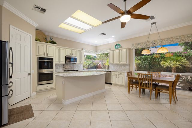 a kitchen with stainless steel appliances granite countertop a refrigerator and microwave