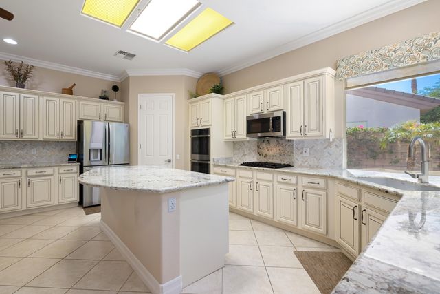 a kitchen with a sink stove and microwave