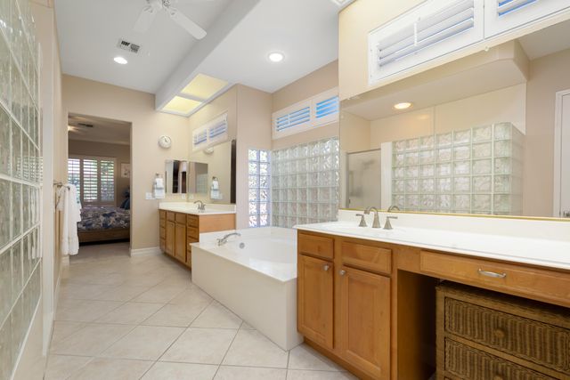 a large white kitchen with a large window