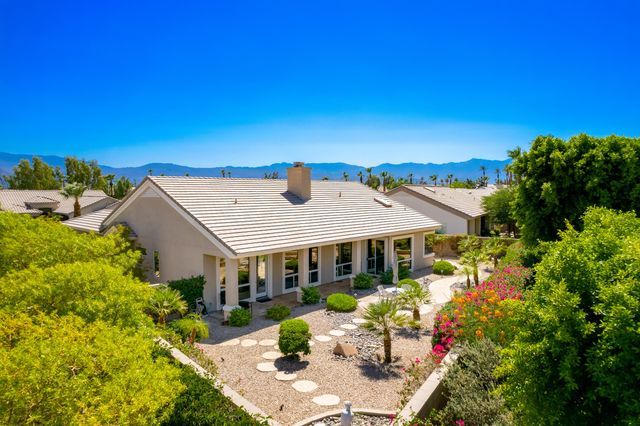 a view of a house with swimming pool and sitting area