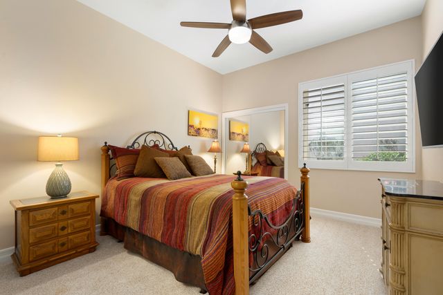 a bedroom with a bed a window and dresser