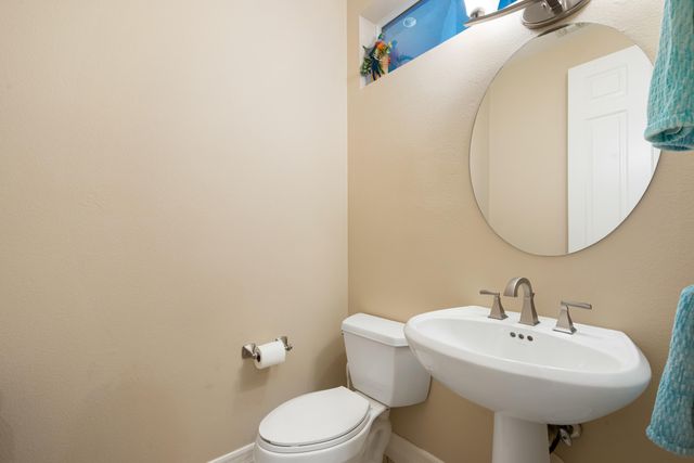 a bathroom with a sink a mirror and toilet