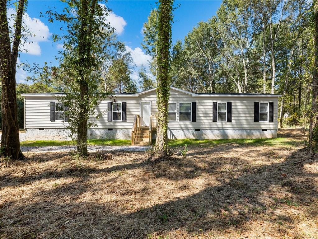 99 Arnold Road Southeast Statham, GA 30666 - Photo 1 of 1 a view of a house with backyard and sitting area