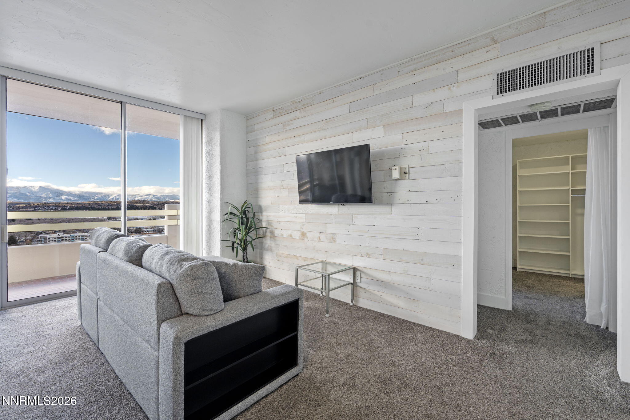 100 North Arlington Avenue, Unit 22G Reno, NV 89501 - Photo 18 of 37 a living room with furniture and a flat screen tv
