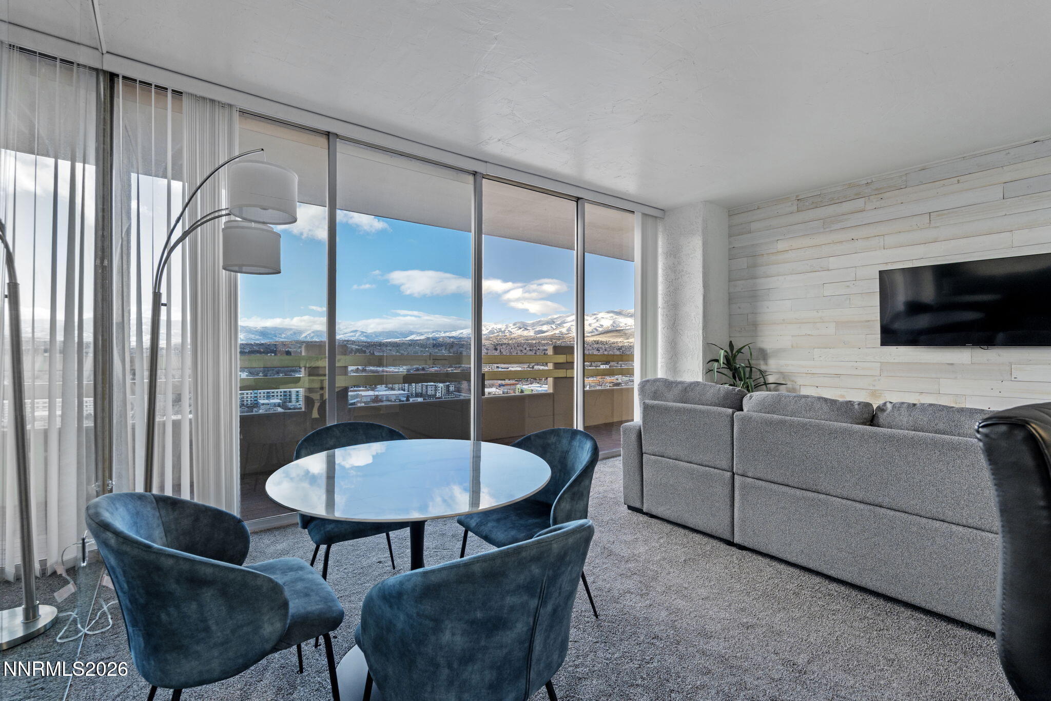 100 North Arlington Avenue, Unit 22G Reno, NV 89501 - Photo 21 of 37 a living room with furniture a flat screen tv and a large window