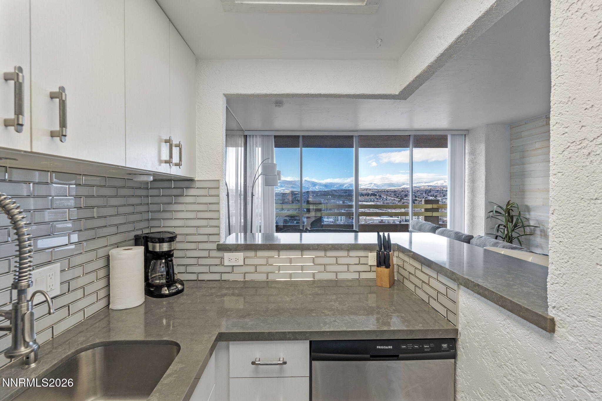 100 North Arlington Avenue, Unit 22G Reno, NV 89501 - Photo 25 of 37 a kitchen with granite countertop a sink and a window