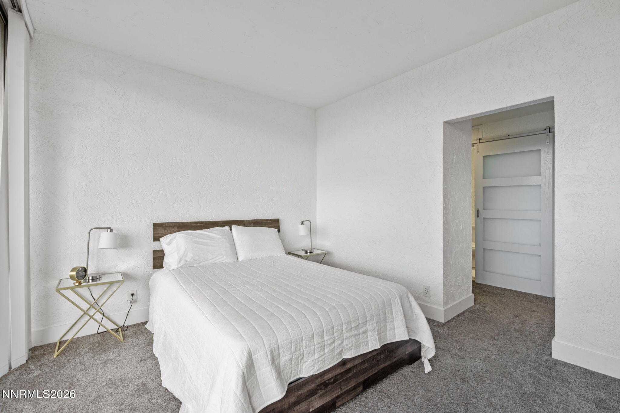 100 North Arlington Avenue, Unit 22G Reno, NV 89501 - Photo 29 of 37 a bedroom with a bed and a table