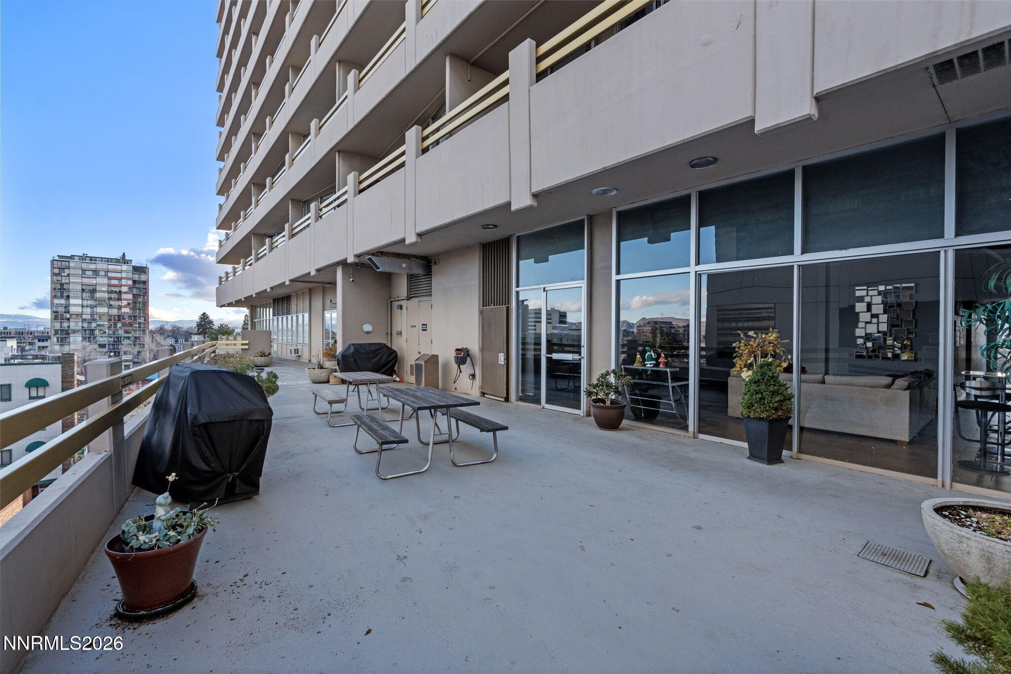 100 North Arlington Avenue, Unit 22G Reno, NV 89501 - Photo 33 of 37 a view of a patio with table and chairs and potted plants