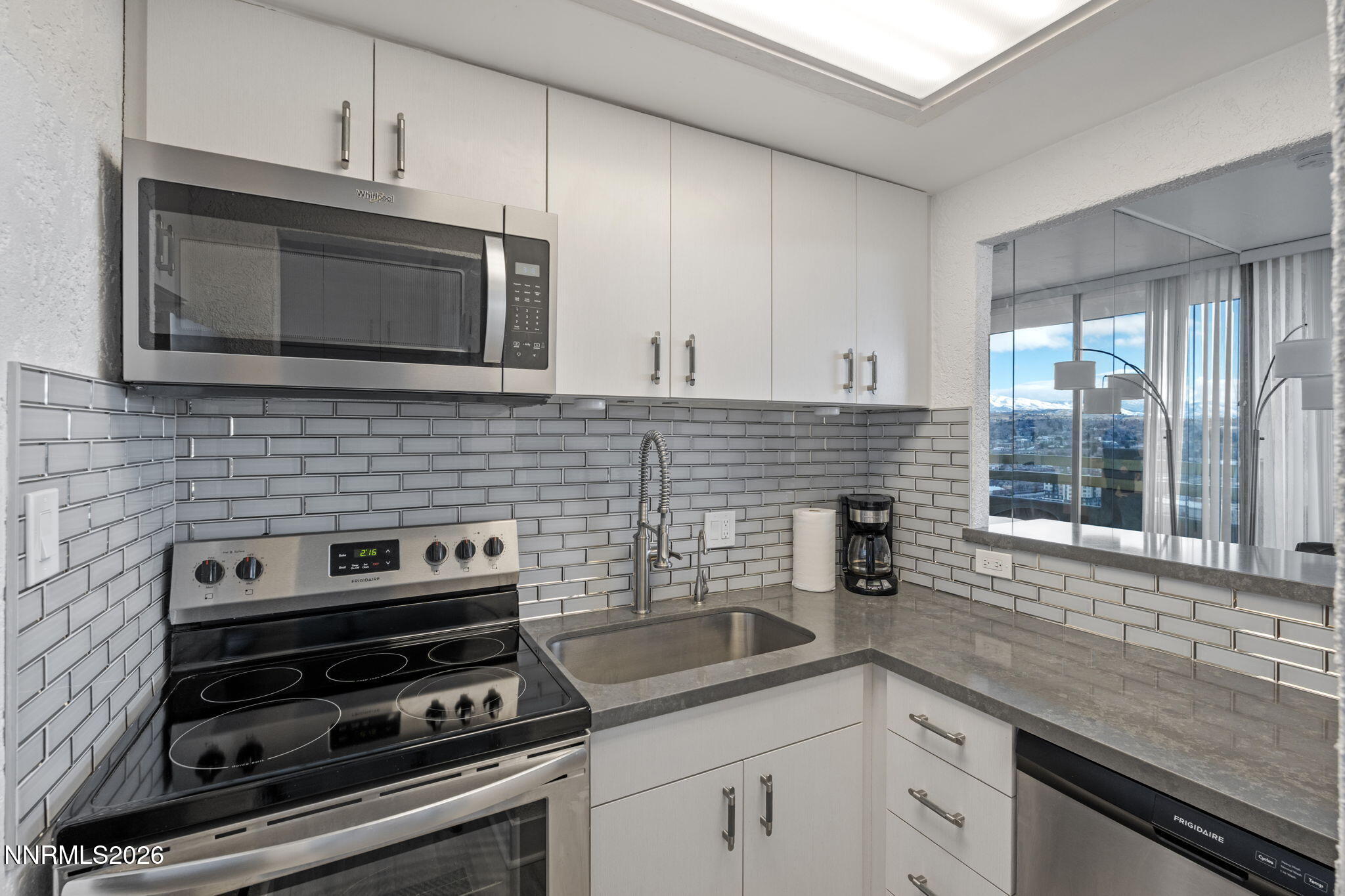 100 North Arlington Avenue, Unit 22G Reno, NV 89501 - Photo 9 of 37 a kitchen with a stove and a microwave