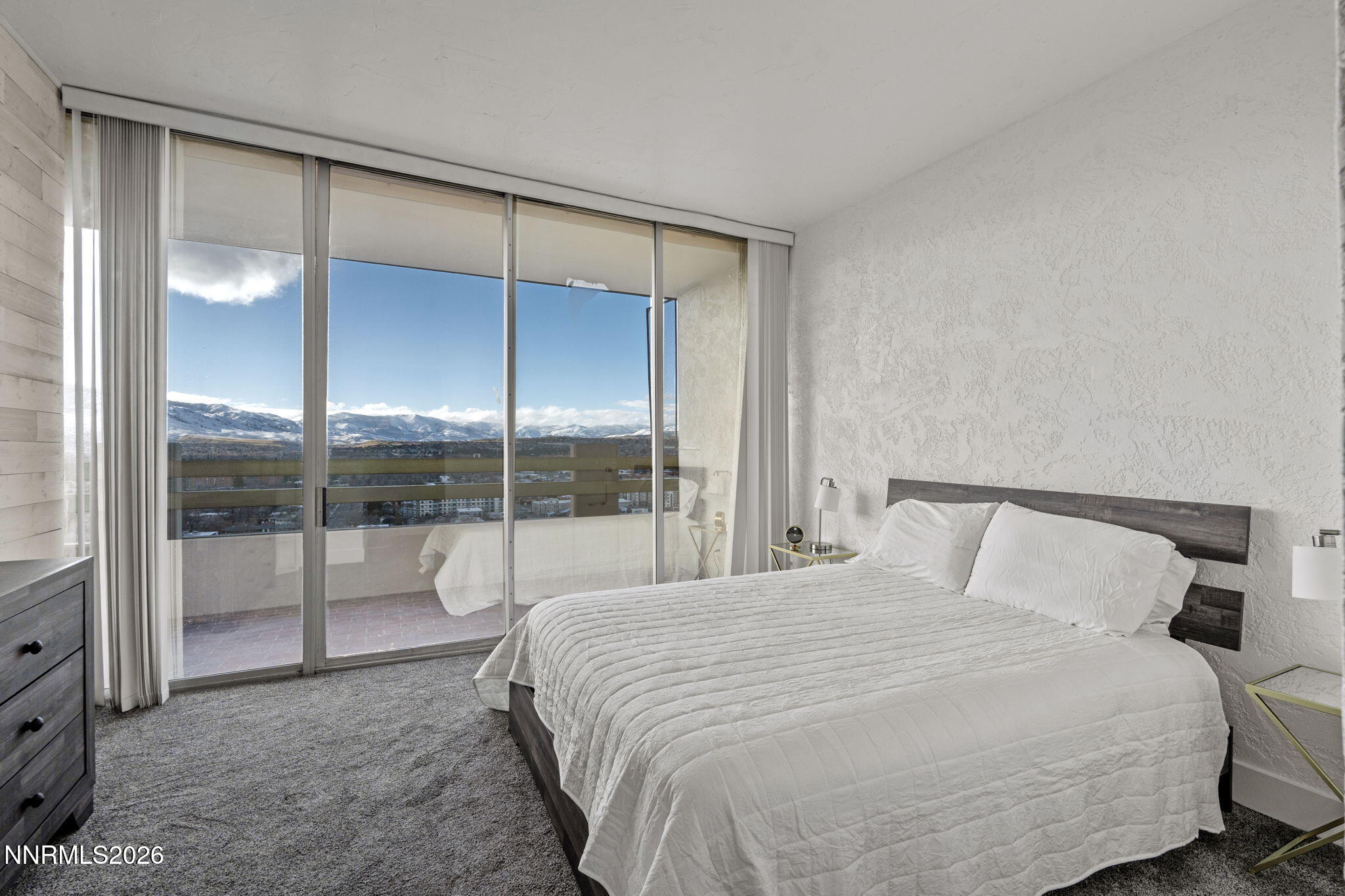 100 North Arlington Avenue, Unit 22G Reno, NV 89501 - Photo 10 of 37 a bedroom with a large bed and glass door