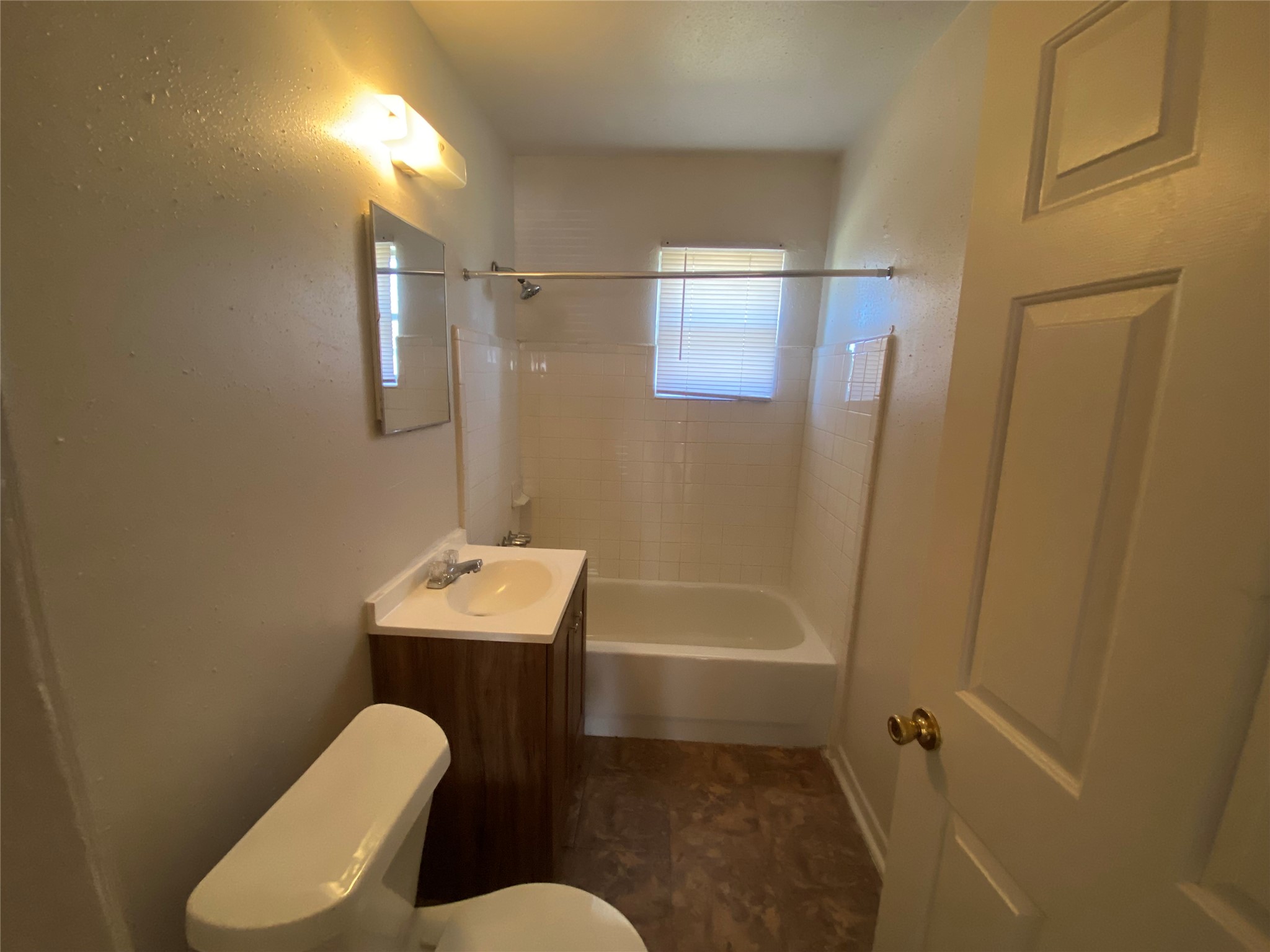 a bathroom with sink mirror bathtub and toilet