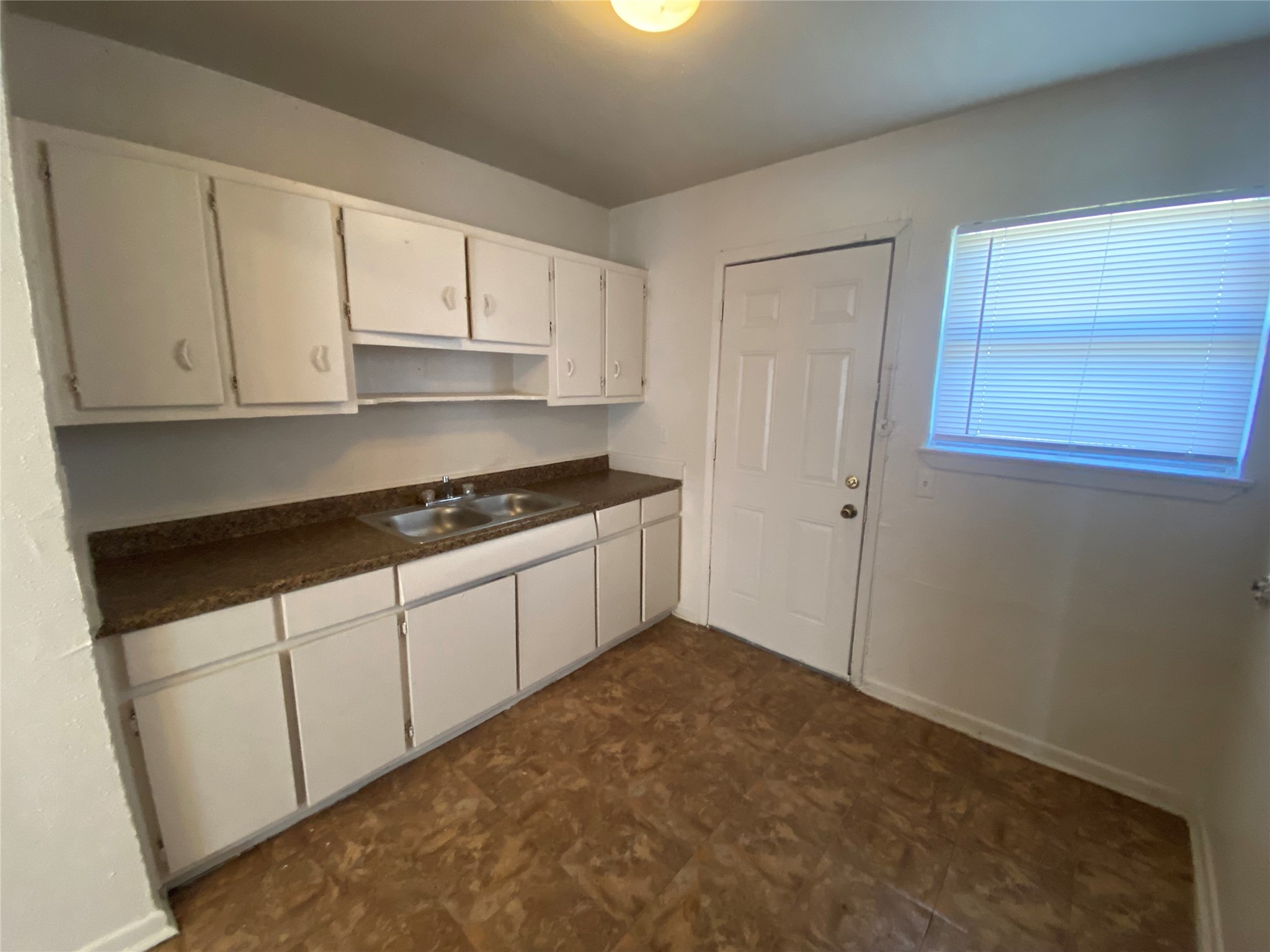 4223 Rockingham Street Houston, TX 77051 - Photo 4 of 13 a kitchen with white cabinets and a stove
