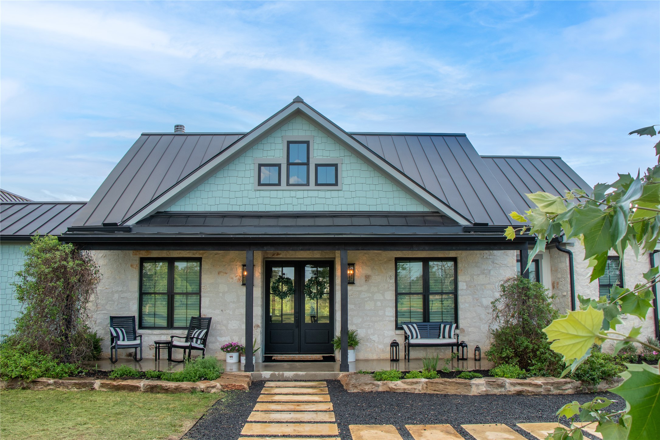272 Slate Rock Road Fredericksburg, TX 78624 - Photo 3 of 32 A charming stone and shingle facade welcomes you to this delightful home with a covered front porch.