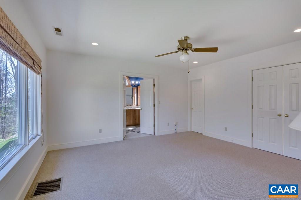 3700 Millington Road Free Union, VA 22940 - Photo 15 of 41 an empty room with closet and a chandelier fan