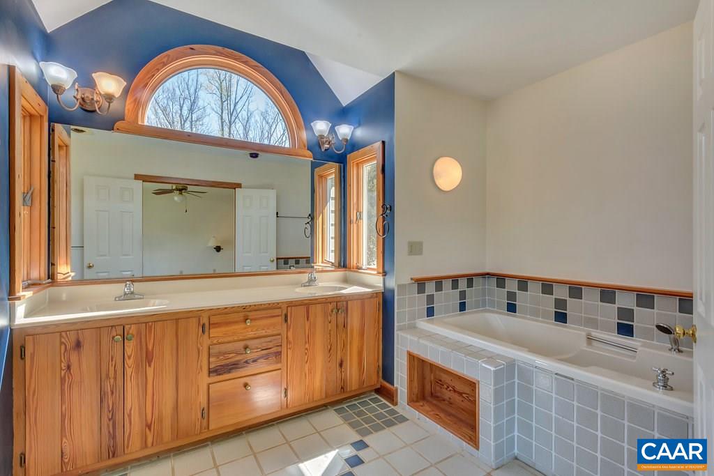3700 Millington Road Free Union, VA 22940 - Photo 19 of 41 a bathroom with a sink a vanity and a mirror