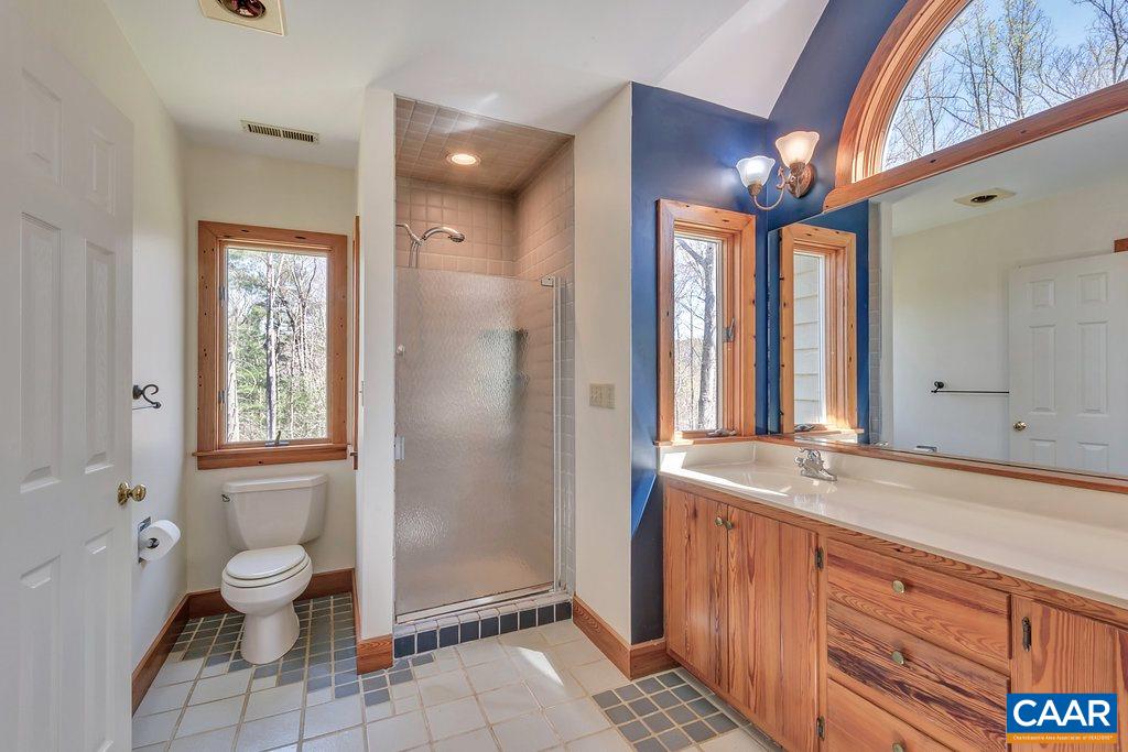 3700 Millington Road Free Union, VA 22940 - Photo 20 of 41 a bathroom with a granite countertop sink toilet and shower