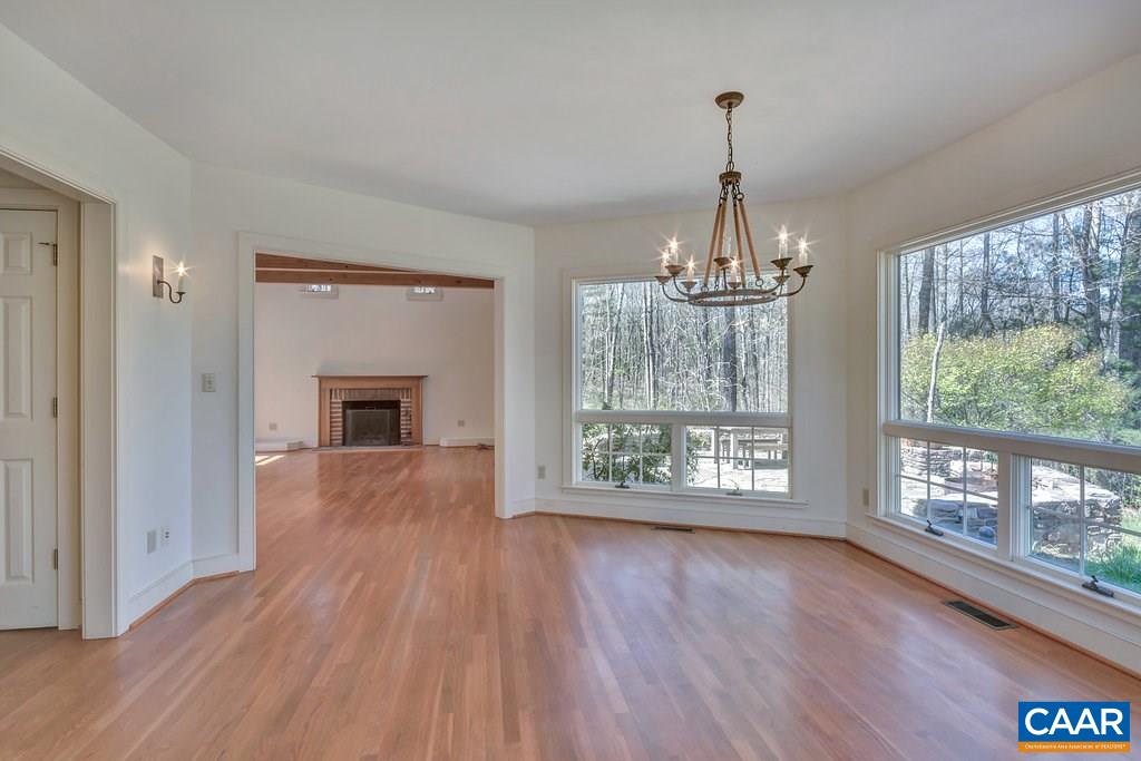 3700 Millington Road Free Union, VA 22940 - Photo 2 of 41 a view of empty room with wooden floor and fireplace