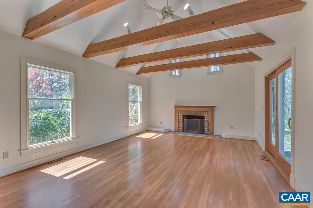 3700 Millington Road Free Union, VA 22940 - Photo 3 of 41 a view of an empty room with wooden floor fireplace and a window