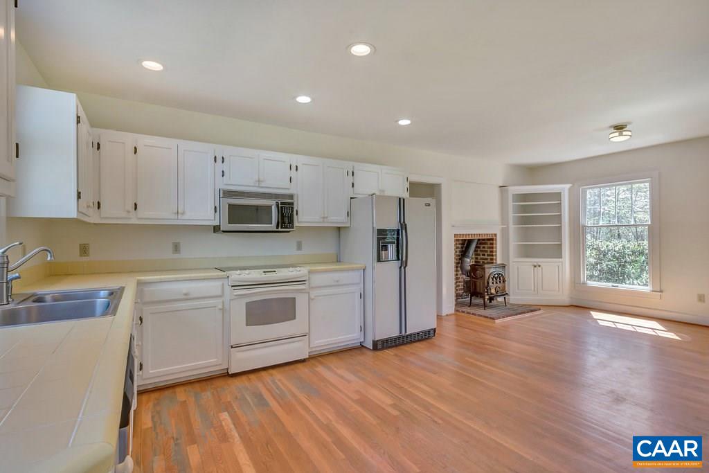 3700 Millington Road Free Union, VA 22940 - Photo 7 of 41 a large kitchen with stainless steel appliances granite countertop a stove a sink dishwasher and a refrigerator with wooden floor