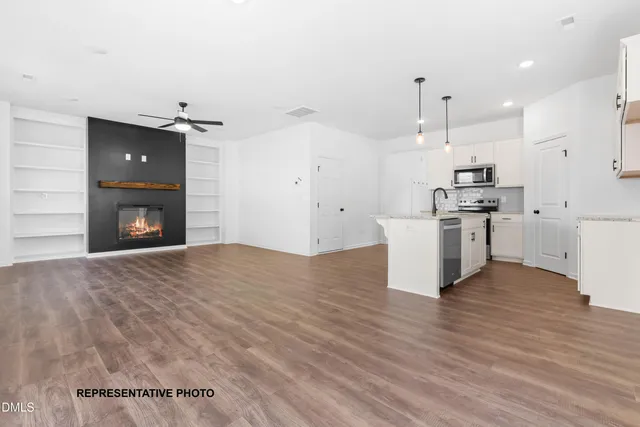 a view of a kitchen with a stove cabinets and wooden floor