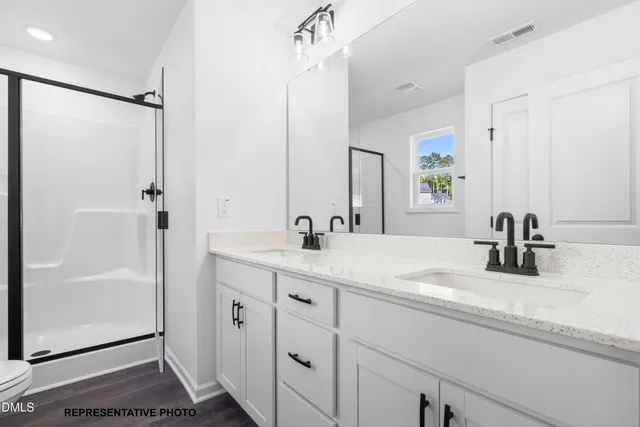 a bathroom with a shower sink and mirror