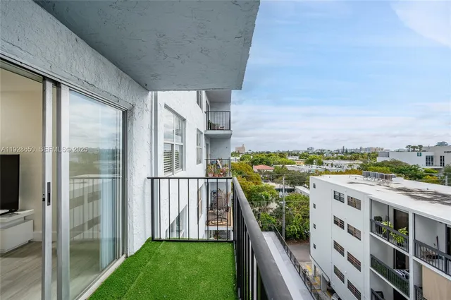 a view of roof deck with furniture and city view