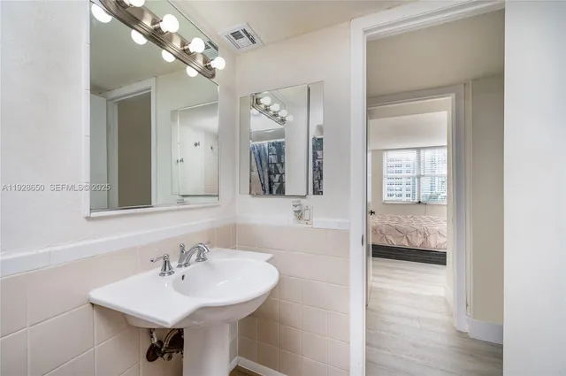 a bathroom with a sink and a mirror