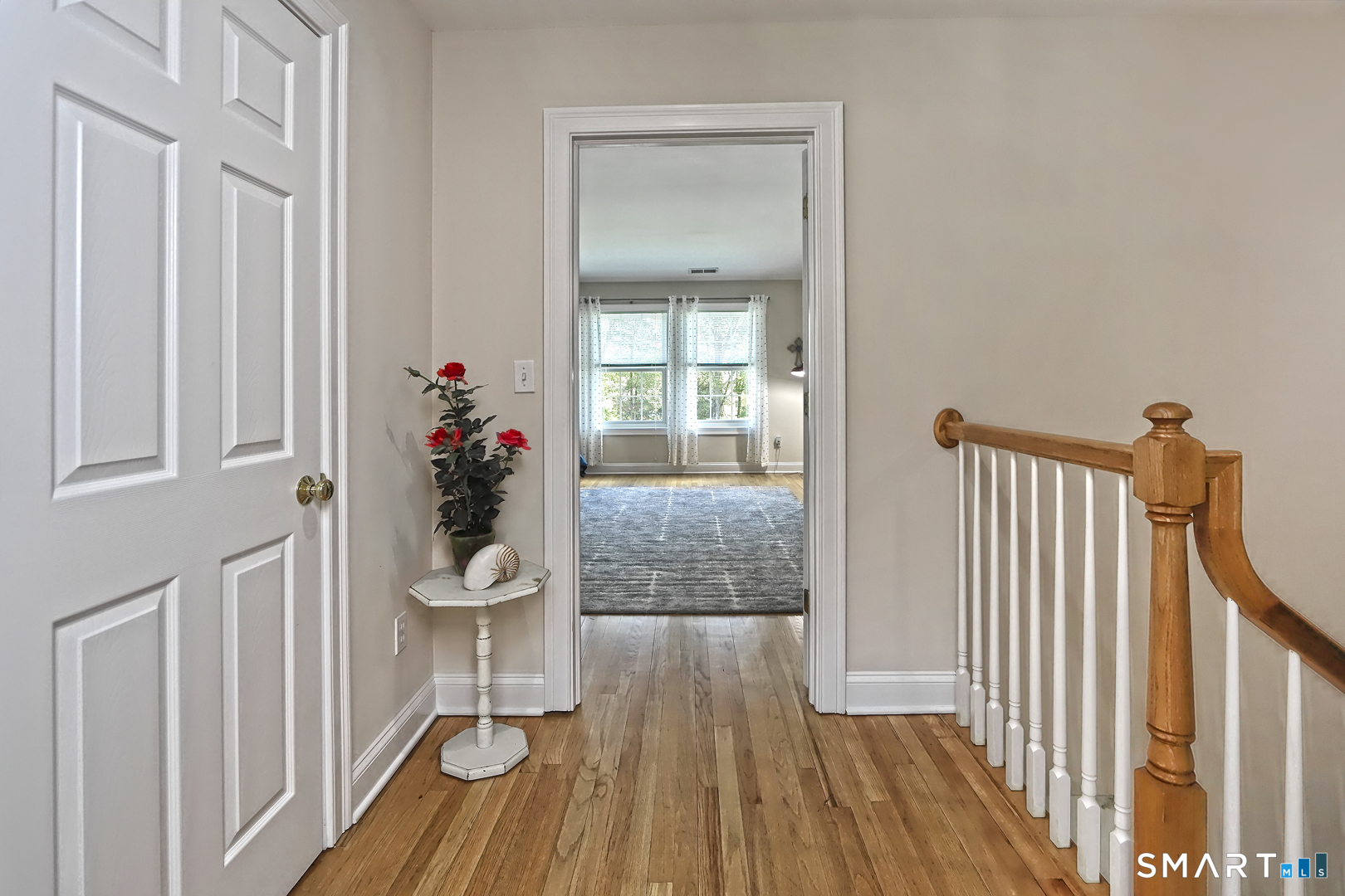 102 Lantern Court, Unit 102 Clinton, CT 06413 - Photo 23 of 36 a view of a hallway and wooden floor and stairs