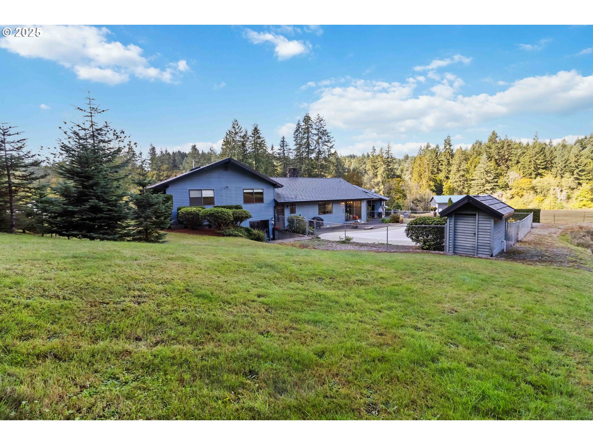 720 Abernathy Creek Road Longview, WA 98632 - Photo 41 of 44 a backyard of a house with table and chairs