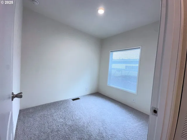an empty room with a empty space and windows