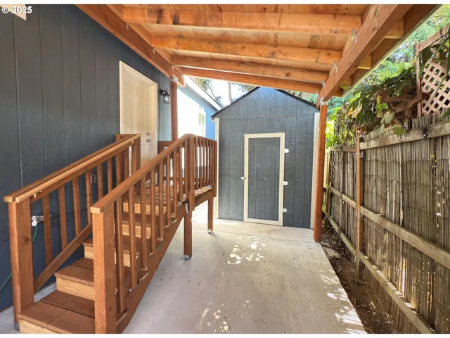 a view of a porch with wooden floor and iron fence