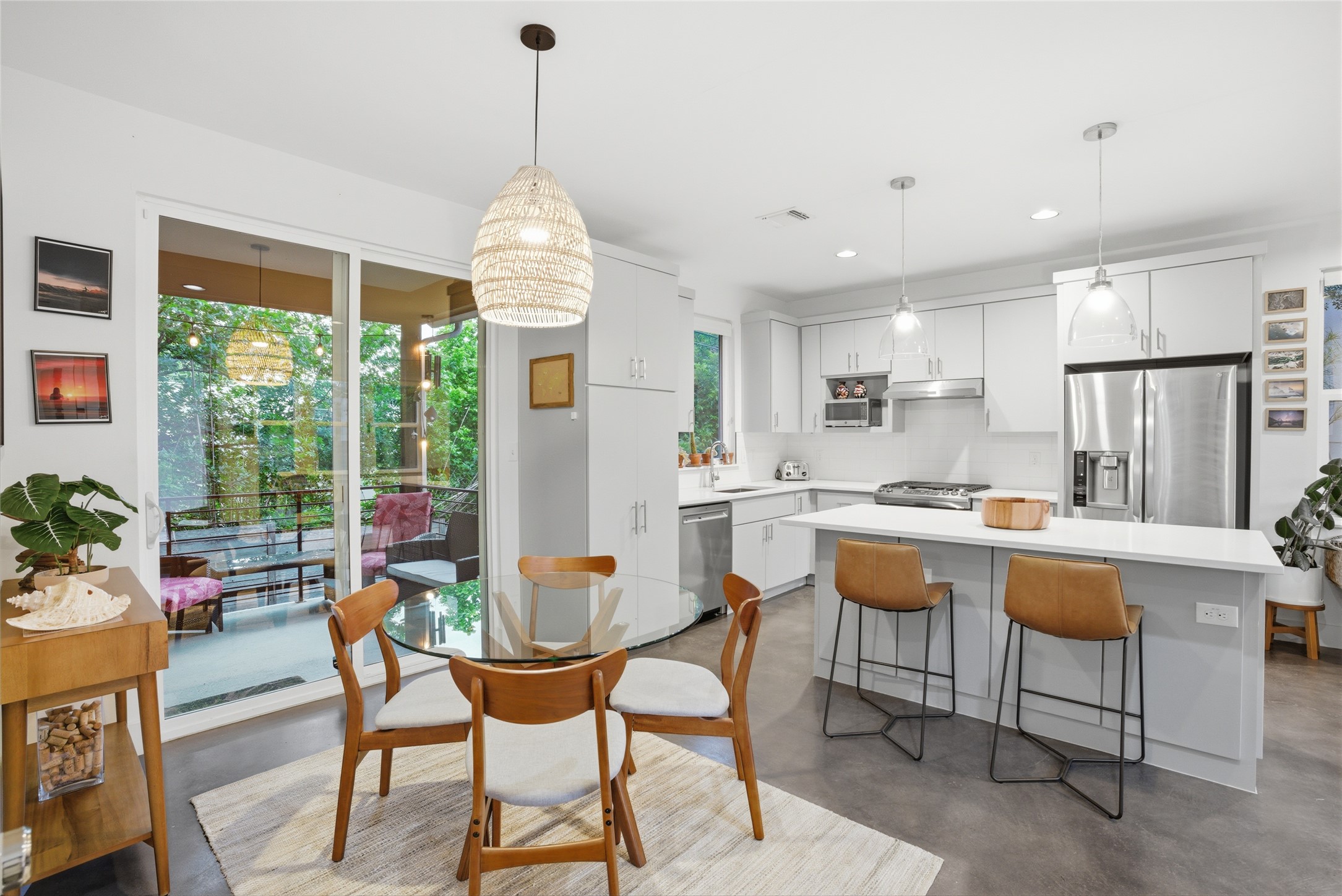 1709 Perez Street, Unit 2 Austin, TX 78721 - Photo 13 of 33 A well-lit kitchen with sleek countertops seamlessly flows into a charming dining area.