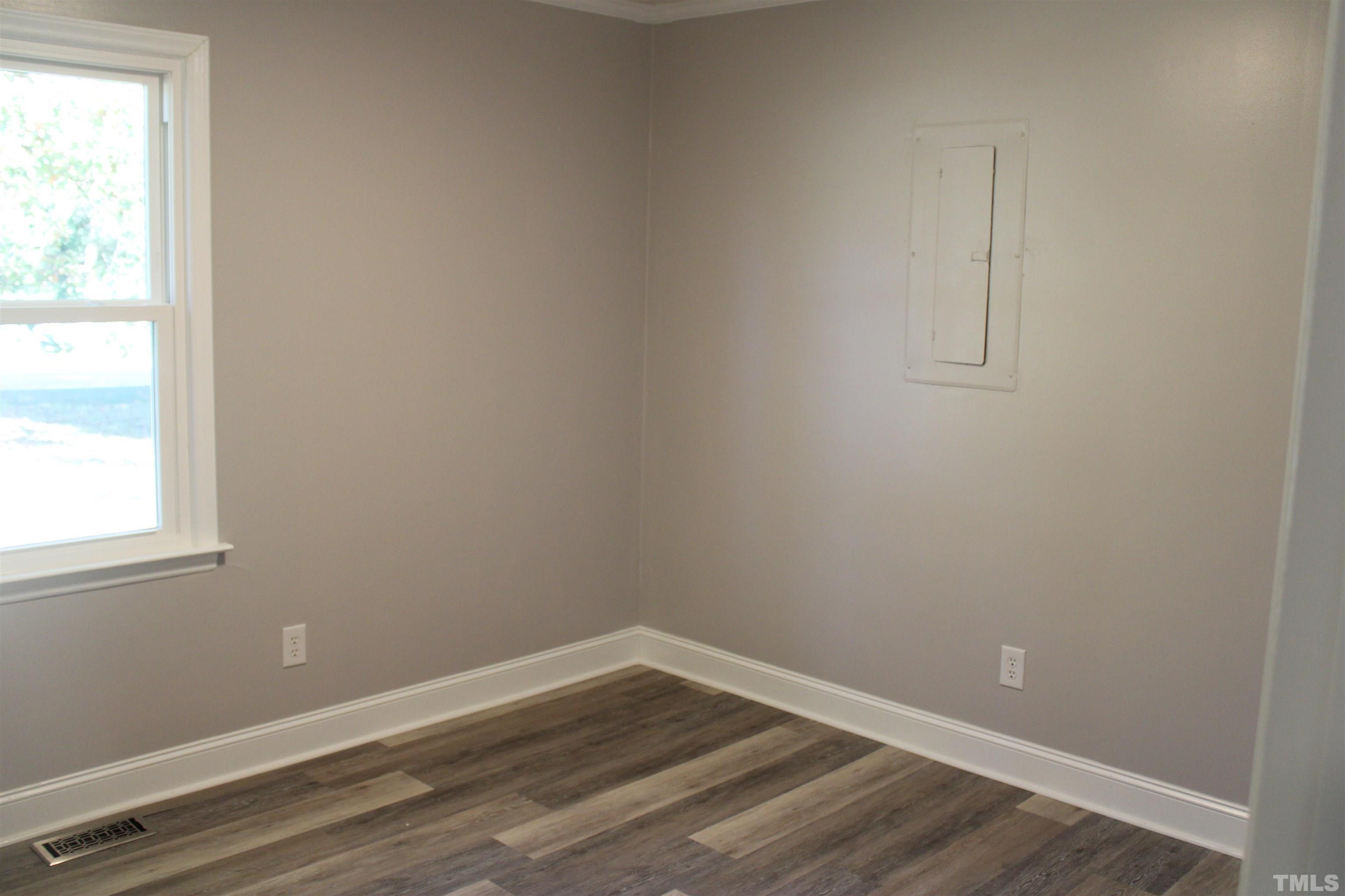 9300 Sauls Road Raleigh, NC 27603 - Photo 12 of 17 an empty room with wooden floor and windows