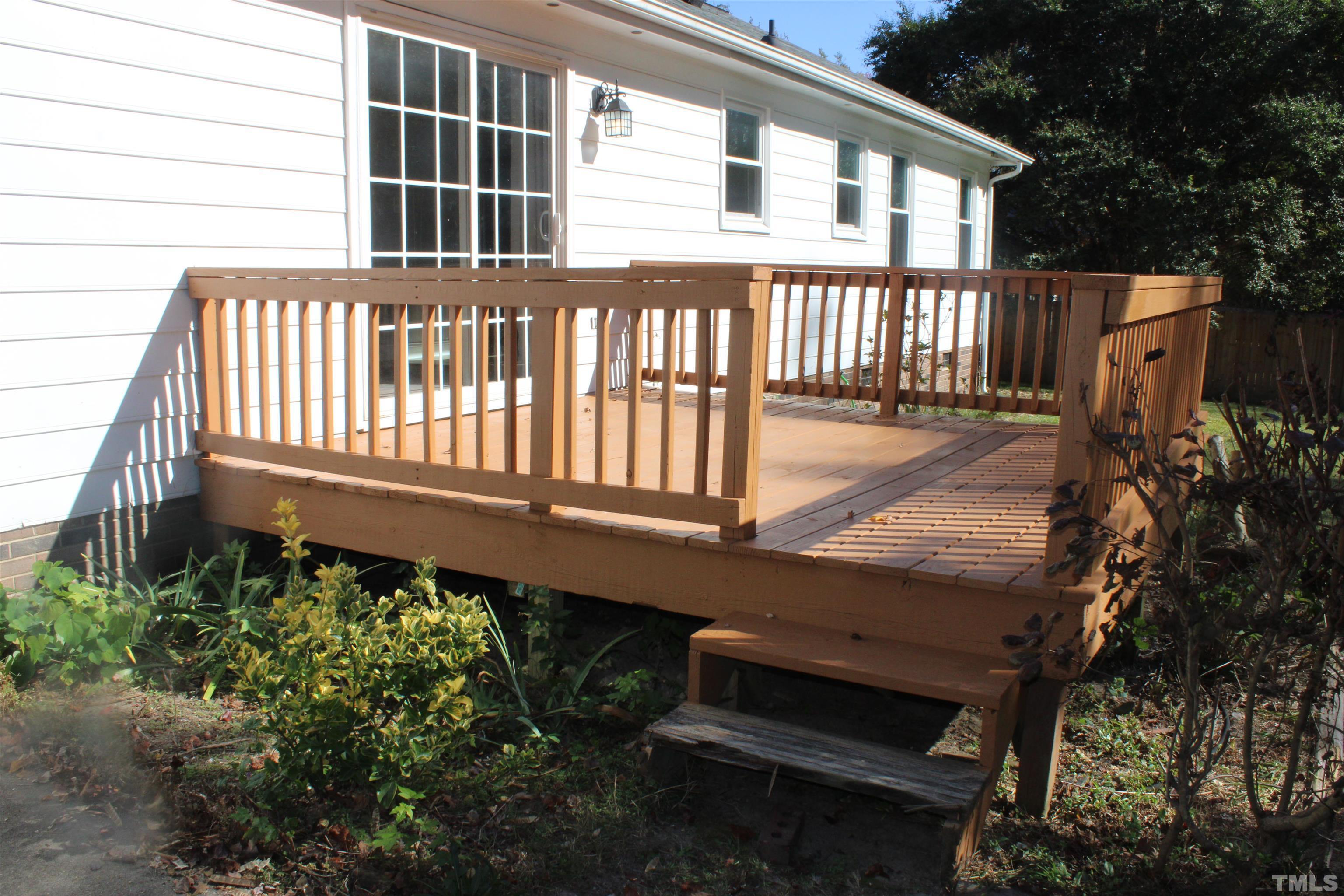 9300 Sauls Road Raleigh, NC 27603 - Photo 15 of 17 a wooden bench sitting in front of a building