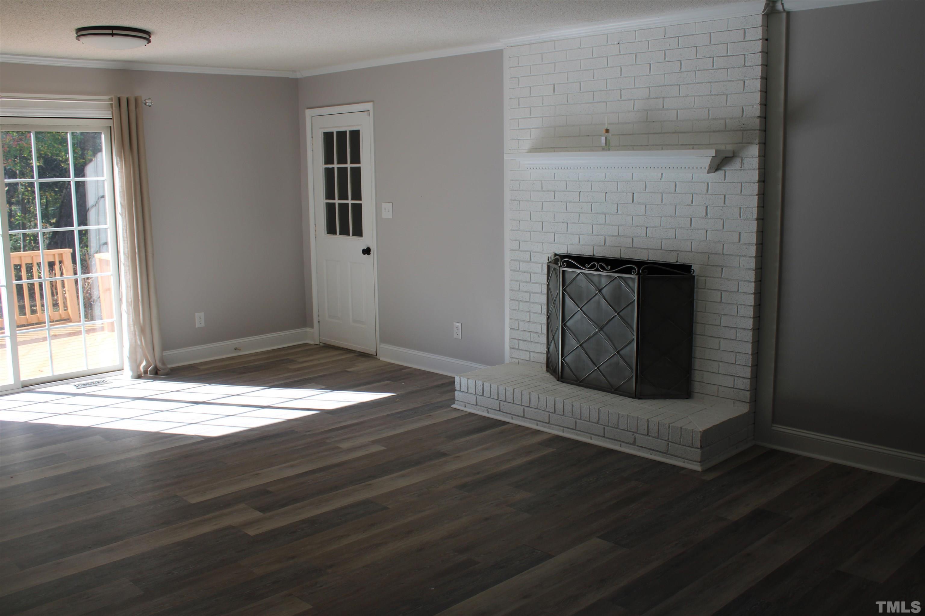 9300 Sauls Road Raleigh, NC 27603 - Photo 2 of 17 a living room with a fireplace