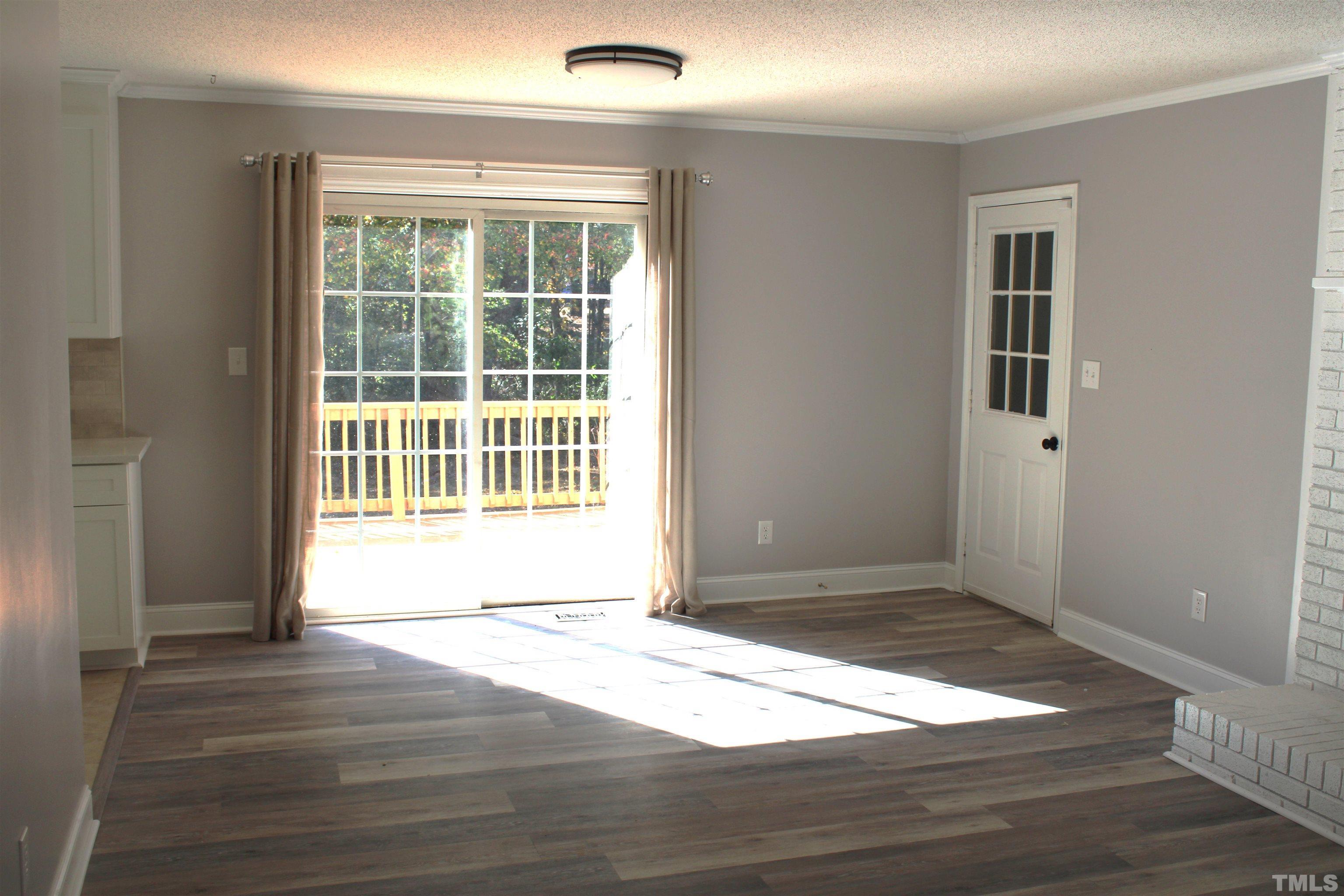 9300 Sauls Road Raleigh, NC 27603 - Photo 5 of 17 a view of an empty room with wooden floor and a window