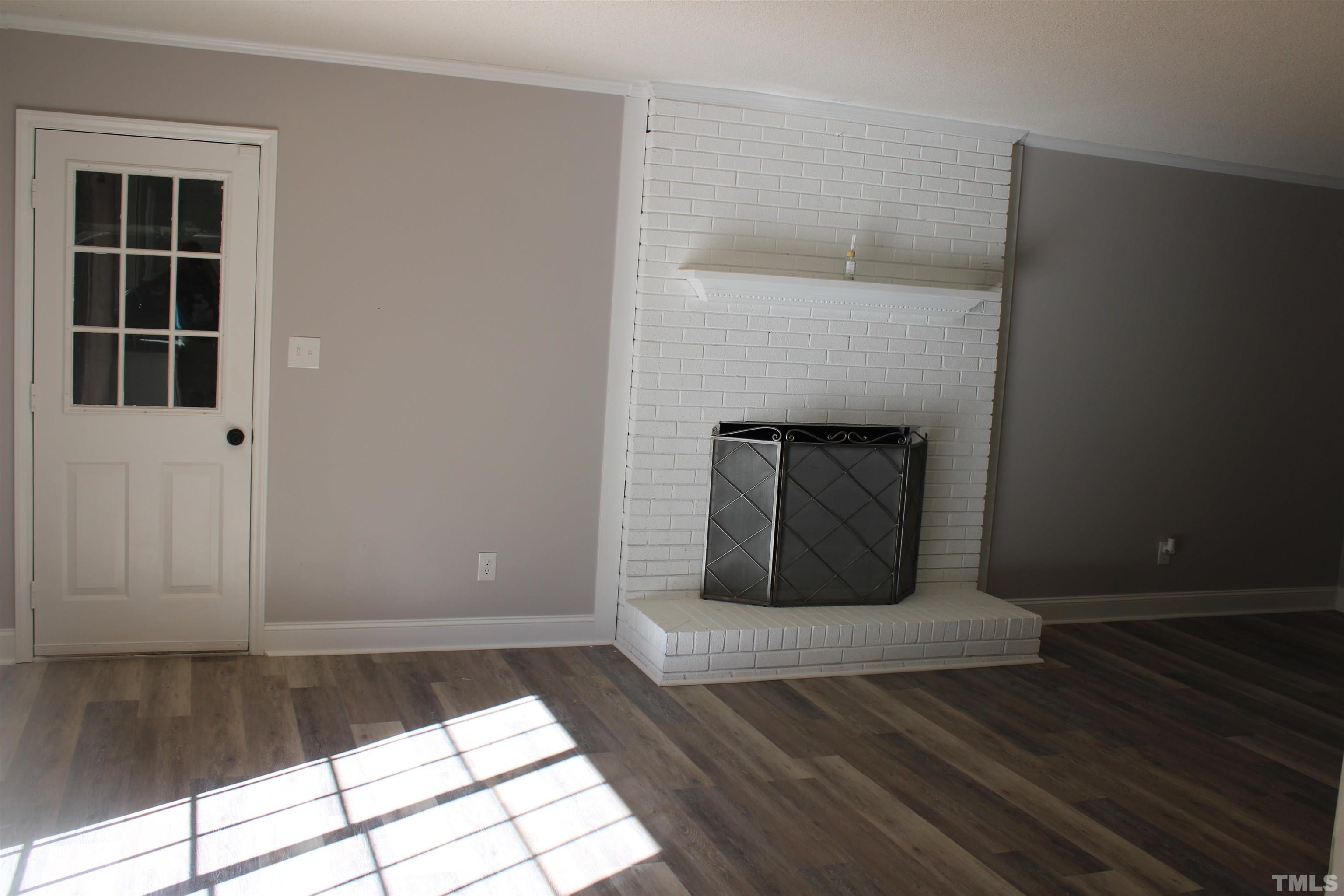 9300 Sauls Road Raleigh, NC 27603 - Photo 6 of 17 a view of an empty room with wooden floor and a window