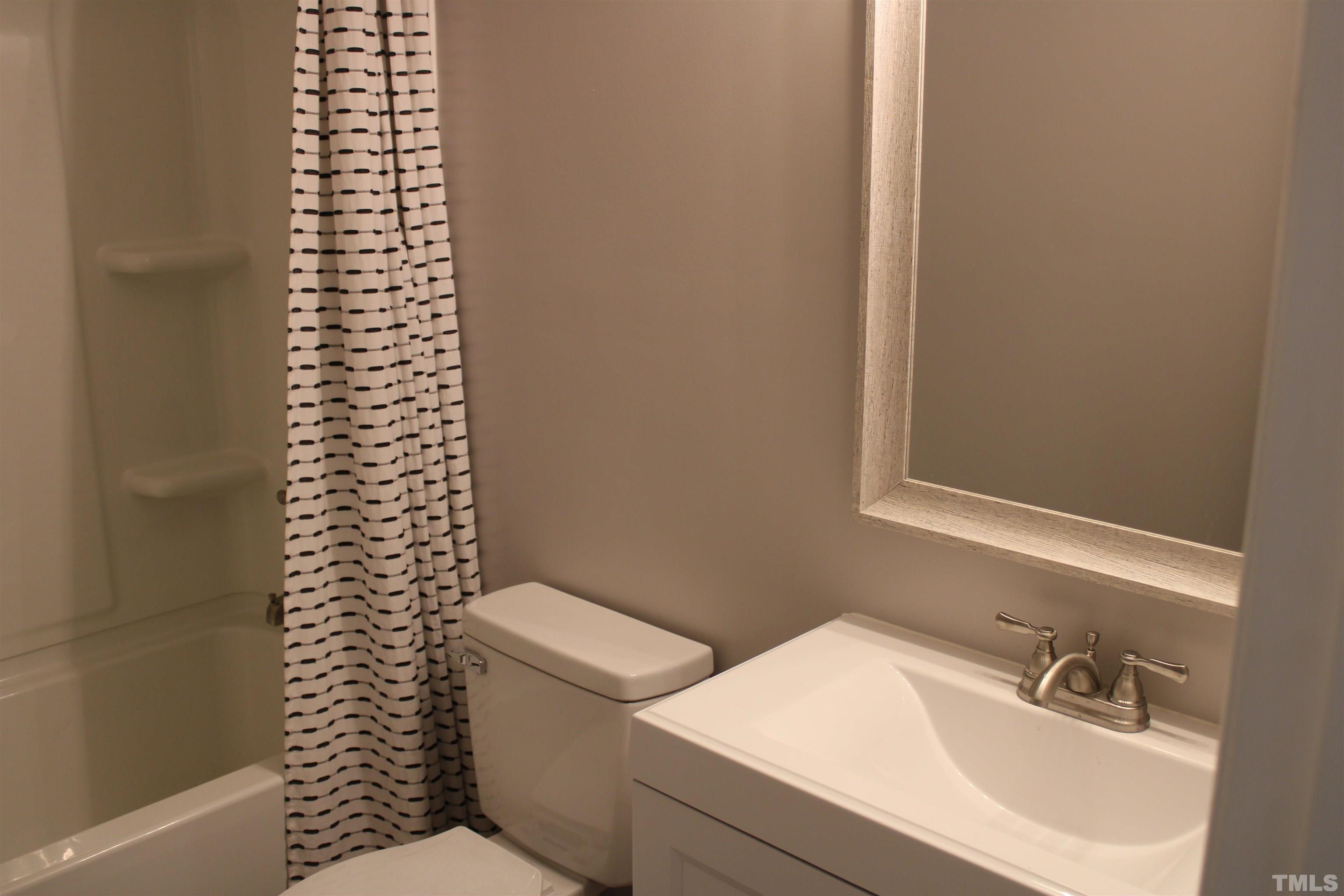 9300 Sauls Road Raleigh, NC 27603 - Photo 9 of 17 a white toilet sitting next to a bathroom sink