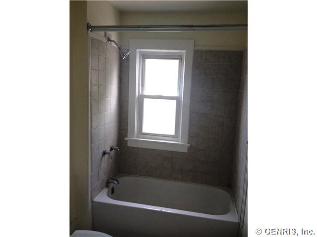426 Magnolia Street Rochester, NY 14611 - Photo 6 of 12 Bathroom. Updated bathroom with tile surround.