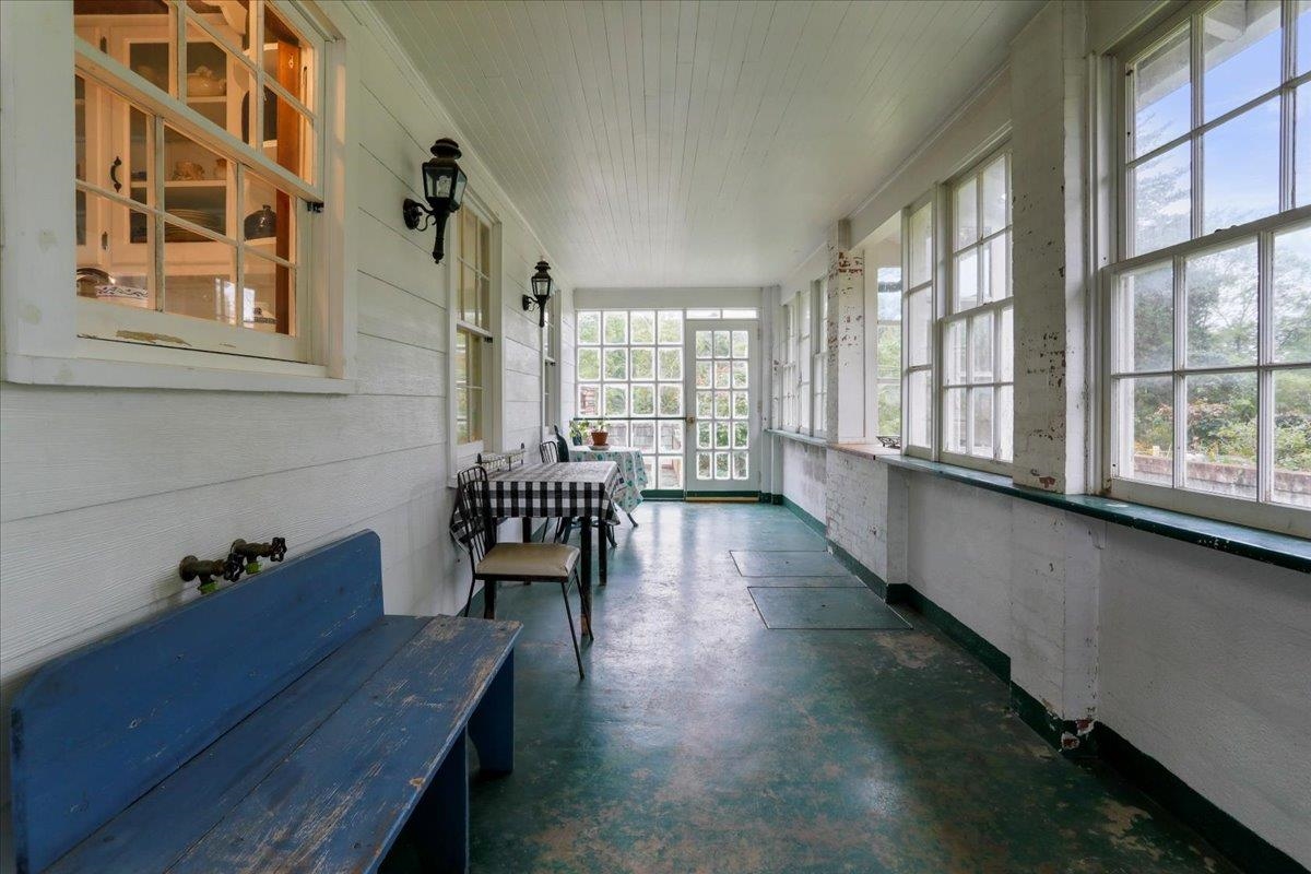 12481 Supinlick Ridge Road Edinburg, VA 22824 - Photo 36 of 75 a hallway with a table and a large window