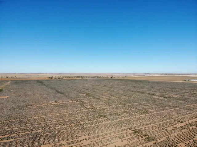 a view of a large building with mountains in the background