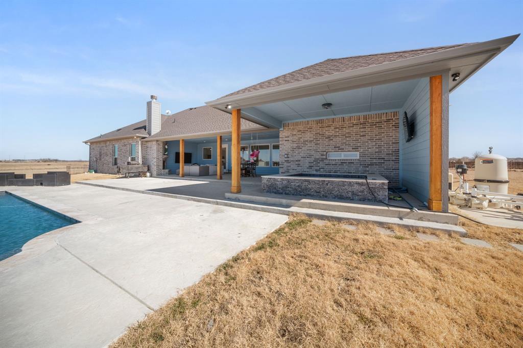 10405 Singleton Road Midlothian, TX 76065 - Photo 29 of 39 Rear view of house featuring an outdoor pool, a patio area, and brick siding