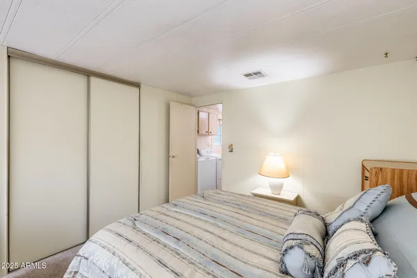 a bedroom with a bed and a large window